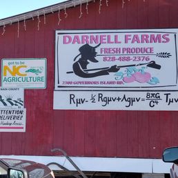 a red barn with a sign that says darnell farms a red barn with a sign that says darnell farms
