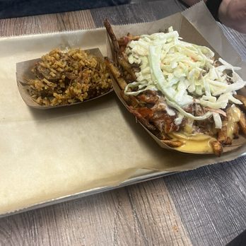 Kiser's Barbeque - A tray holds a loaded baked potato topped with coleslaw and a side of cooked vegetables, served on parchment paper at a restaurant. - Barbeque Near Me - Athens, Ohio