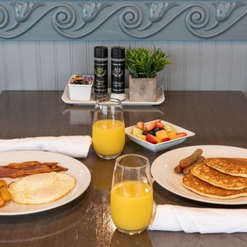 Baha Grille - a breakfast of pancakes, eggs, bacon, and orange juice - American Near Me - Stuart, Florida