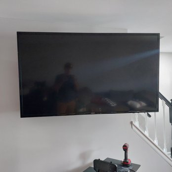 T&S Custom Projects - a flat screen tv mounted on the wall - Handyman Near Me T&S Custom Projects - a flat screen tv mounted on the wall - Handyman Near Me