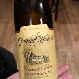 a hand holding a bottle of wine a hand holding a bottle of wine