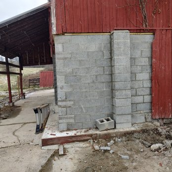 Branch Construction - a red barn with a brick wall - General Contractors Near Me