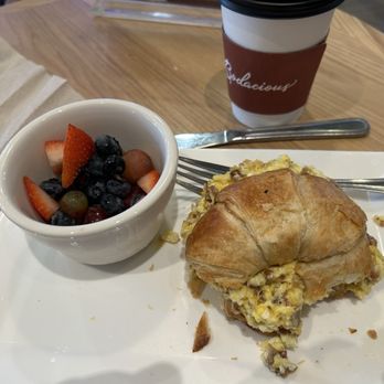 The Bodacious Olive - The Julia Child breakfast sandwich with fruit cup, and coffee. - Specialty Food Near Me - Pensacola, Florida The Bodacious Olive - The Julia Child breakfast sandwich with fruit cup, and coffee. - Specialty Food Near Me - Pensacola, Florida