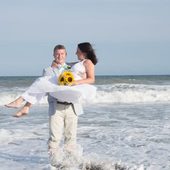 Billy Beach Photography - Groom sweeps up his bride in the surf at Topsail Island, NC - Event Photography Near Me - Wilmington, North Carolina Billy Beach Photography - Groom sweeps up his bride in the surf at Topsail Island, NC - Event Photography Near Me - Wilmington, North Carolina