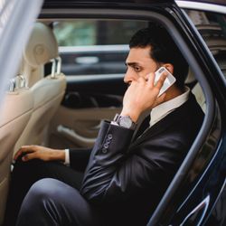 Black and Silver Rides - Client enjoying chauffeur black car service.
