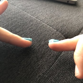 Modern Nails - Inconsistent thickness of the liquid gel nails. Comparing both right and left ring fingers. - Nail Salons Near Me - Tampa, Florida