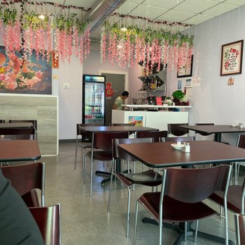 Broccoli - a woman sitting at a table in a restaurant - Asian Fusion Near Me - Schiller Park, Illinois
