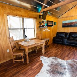 Walnut Canyon Cabins - The dining area, electric fireplace and reclining leather love seat