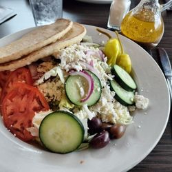 Olympia Restaurant - Greek salad with kalamata olives and warm pita, served with cruet of Greek dressing.