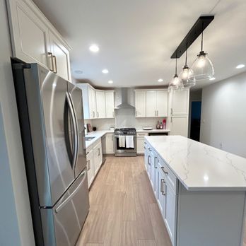Martell Builders - An all white kitchen can really help brighten and heighten a space! The mixed metals in this design add a modern element to a classic style! - General Contractors Near Me - Sparrow Bush, New York