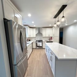 Martell Builders - An all white kitchen can really help brighten and heighten a space! The mixed metals in this design add a modern element to a classic style!