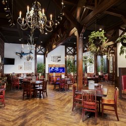 Dons Seafood - Lafayette - Lafayette's main dining room blends rustic wood trusses and wrought-iron chandeliers with a cozy stone fireplace and a striki...