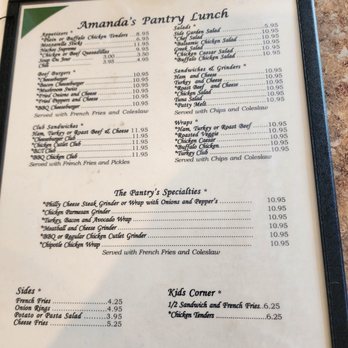 The Pantry - Lunch menu - The menu titled 'Amanda's Pantry Lunch' includes sections for appetizers, burgers, club sandwiches, salads, sandwiches & grinders, wraps, specialties, sides, and kids' corner. It lists food items such as chicken tenders, cheeseburgers, club sandwiches, salads, and wraps, with prices ranging from around $3 to $11.95. The menu notes that all items are served with French fries and coleslaw, and includes a disclaimer about food safety. The layout is organized with item names, prices, and some descriptions, on a white background with green accents. - Diners Near Me - Westerly, Rhode Island