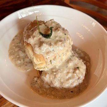 Santiago's Bodega - Buttermilk biscuits with sausage gravy. - Spanish Near Me - Altamonte Springs, Florida Santiago's Bodega - Buttermilk biscuits with sausage gravy. - Spanish Near Me - Altamonte Springs, Florida
