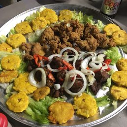 Platter of carne frita, chicharrónes de pollo and tostones. SO GOOD!!!!