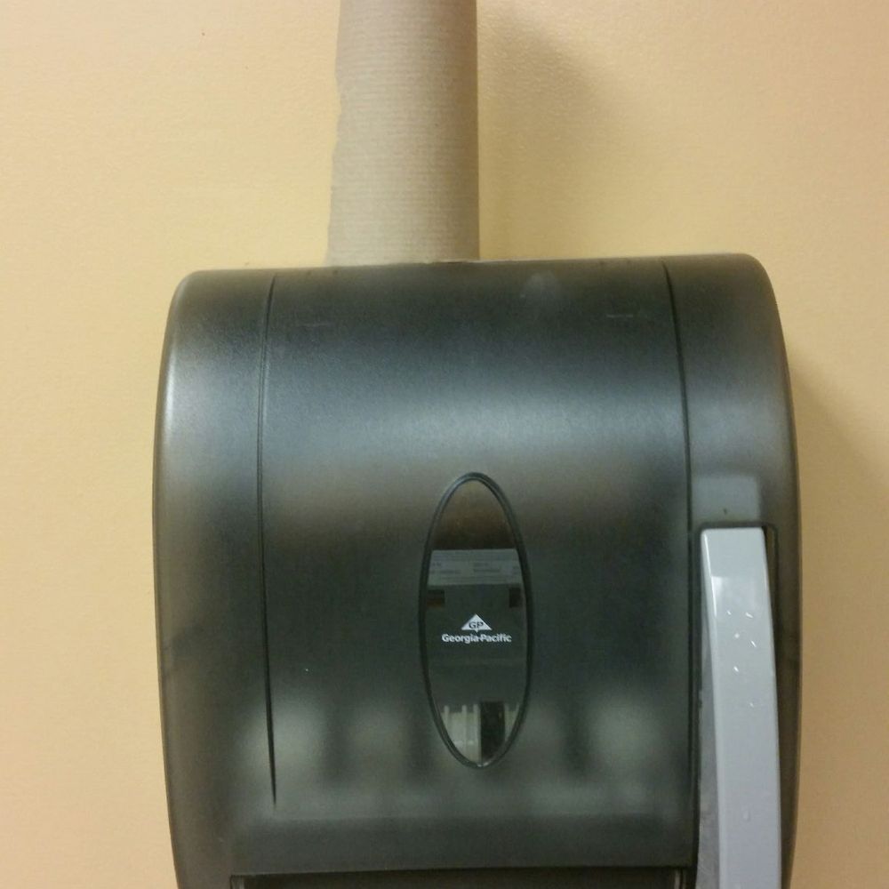 Yes, this is the paper towel. A partial roll sitting on top of an empty dispenser. Yes, this is the paper towel. A partial roll sitting on top of an empty dispenser.