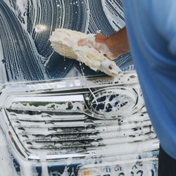 Aqua Hand Car Wash & Mobile Detail - Care from top to bottom--Jeff reaching across the roof during a hand wash.