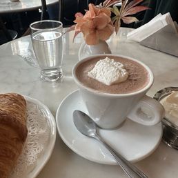 Hot chocolate with a side of whipped cream. Hot chocolate with a side of whipped cream.