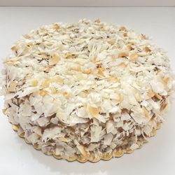 Full Life Gourmet Bakery - Indulge in paradise with our gluten-free, sugar-free, dairy-free Coconut Cake--rich, moist, and topped with golden coconut flakes & caramel