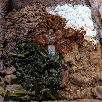 Delish Ethiopian Cuisine - Meat Combo: kaye wot, alicha wot, kitfo, gomen, and Ethiopian cheese - Ethiopian Near Me - Seattle, Washington Delish Ethiopian Cuisine - Meat Combo: kaye wot, alicha wot, kitfo, gomen, and Ethiopian cheese - Ethiopian Near Me - Seattle, Washington