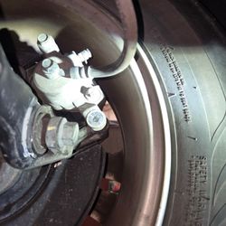 Richbourg Certified Auto Service - Missing bolts from back passenger tire discovered by another mechanic I paid to investigate my vehicle.