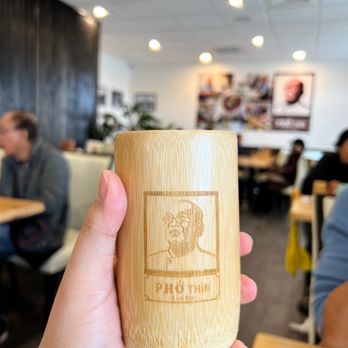 Pho Thin - a hand holding a bamboo cup - Vietnamese Near Me - Westminster, California