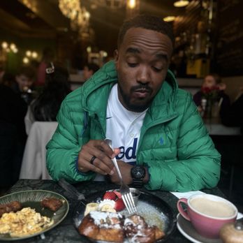 Grounded Coffee - Very hungry young man enjoying French Toast, chai latte, scrambled eggs, and vegan sausage - Breakfast & Brunch Near Me - London, XGL