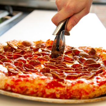 Jimmy Chew's - a pepperoni pizza being sliced - Pizza Near Me - Barrie, Ontario