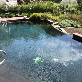 Pool Girl - Black plaster pool with tile accents and vanishing edge waterfall - Pool Cleaners Near Me Pool Girl - Black plaster pool with tile accents and vanishing edge waterfall - Pool Cleaners Near Me