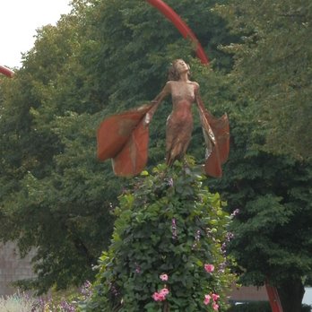EOS - In the summer, flowering vines surround the base of the sculpture - Public Art Near Me EOS - In the summer, flowering vines surround the base of the sculpture - Public Art Near Me