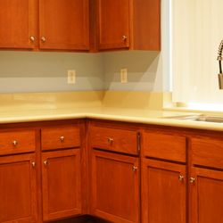 Miller Cabinetry & Millworks - Comparing the color of the repair in the lower cabinets to existing top cabinets. Clear coat protections.