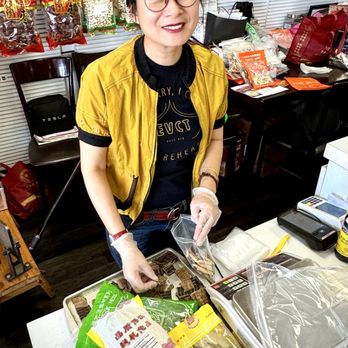 Tan Hua - The owner preparing a blend of four teas for a specific physical issue. - Traditional Chinese Medicine Near Me - Mesa, Arizona Tan Hua - The owner preparing a blend of four teas for a specific physical issue. - Traditional Chinese Medicine Near Me - Mesa, Arizona