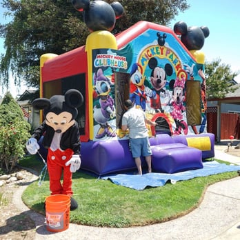 Jenny's Jumpers - Mickey Mouse trying to get the kids attention while inside the jumper..sorry Mickey they are still busy jumping - Bounce House Rentals Near Me Jenny's Jumpers - Mickey Mouse trying to get the kids attention while inside the jumper..sorry Mickey they are still busy jumping - Bounce House Rentals Near Me