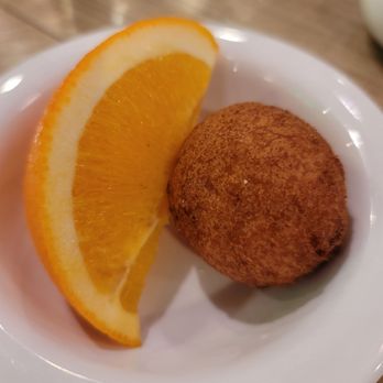 Lou Mitchell's - An orange slice. Thinking the little ball is a Chicago-style beignet, without the powdered sugar. - Breakfast & Brunch Near Me - Chicago, Illinois