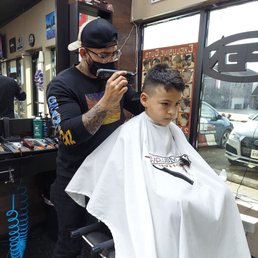Zach getting hair cut from Freddy
