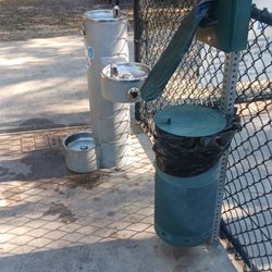 New Tampa Rotary Dog Park - Poop bag dispenser, trash can and water fountain just inside gate