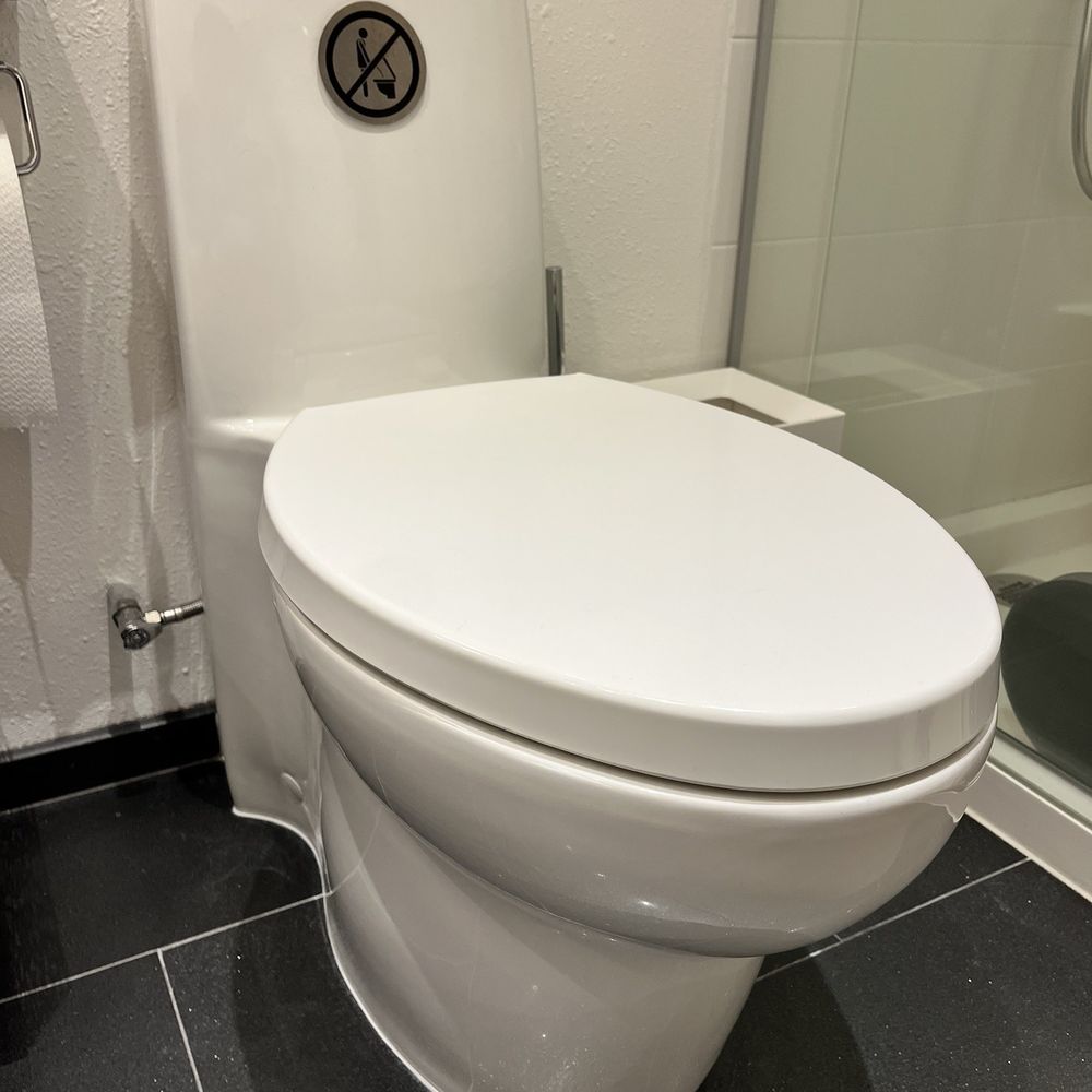 One-piece Kohler Saile toilet, professionally reset by Chris after it had become loose from one of its hidden mounting brackets.