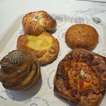 Paris Baguette - Hojicha muffin (bot L), Pineapple Brulee Pastry (middle L), hashbrown potato (top L), Crab Meat Croquette (top R), 4 Cheese Quiche (bot R) - Bakeries Near Me - Miami, Florida Paris Baguette - Hojicha muffin (bot L), Pineapple Brulee Pastry (middle L), hashbrown potato (top L), Crab Meat Croquette (top R), 4 Cheese Quiche (bot R) - Bakeries Near Me - Miami, Florida