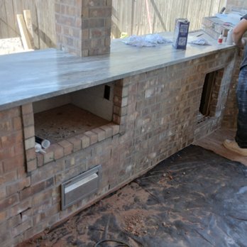 NWT Home Services - a man working on an outdoor kitchen - Roofing Near Me NWT Home Services - a man working on an outdoor kitchen - Roofing Near Me