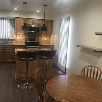 Casco Remodeling - Kitchen with new cabinets, flooring, backsplash, 8 insert lights, under cabinet lights, microwave with exhaust and pendant lights - General Contractors Near Me - Clawson, Michigan