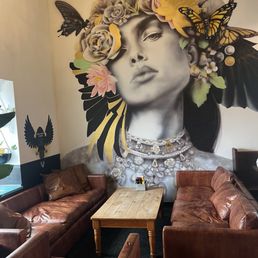 Lived in leather couch with corner dining with big window for people watching.