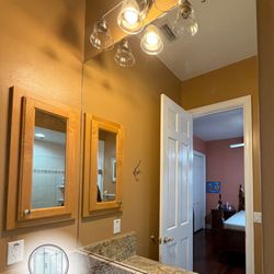 Tampa Bay Glass Masters - After photo of a brown themed bathroom with a bronze granite vanity and a 45''x53'' custom mirror.