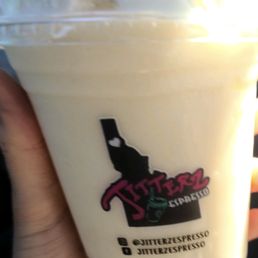 a hand holding a cup of ice cream