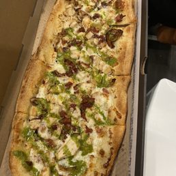 Chicken bacon ranch pizza with pesto drizzle