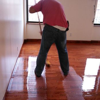 Caesar's Wood Floor - a man using a mop to clean a hardwood floor - Flooring Near Me - Astoria, New York Caesar's Wood Floor - a man using a mop to clean a hardwood floor - Flooring Near Me - Astoria, New York