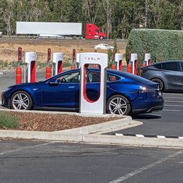There's a Tesla charging station available right next to hotel for about 8 vehicles