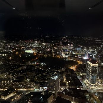 View Boston - Nighttime city skyline with illuminated buildings, streets, and a dark sky, viewed from a high-rise observation deck. - Observatories Near Me - Boston, Massachusetts