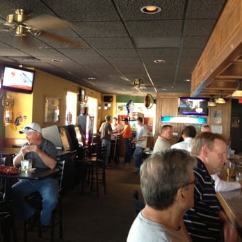 Escape Lounge - a group of people sitting at a bar - Lounges Near Me - Johnston, Iowa