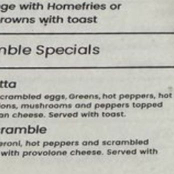 Donna's Cafe - Description of scrambles - A menu section displays Italian scramble options, including Giambotta priced at $16.99 and Italian Scramble at $14.99. Descriptions detail ingredients such as eggs, greens, hot peppers, sausage, onions, mushrooms, parmesan cheese, and provolone cheese, with serving suggestions like toast. - Breakfast & Brunch Near Me - Rome, New York