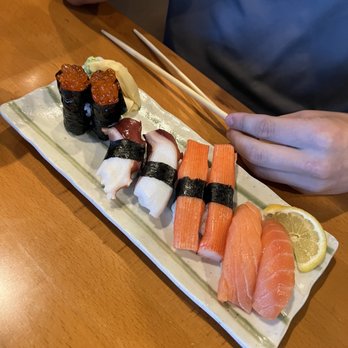 Musashi - a person sitting at a table with a plate of sushi and chopsticks - Japanese Near Me - Morehead City, North Carolina Musashi - a person sitting at a table with a plate of sushi and chopsticks - Japanese Near Me - Morehead City, North Carolina
